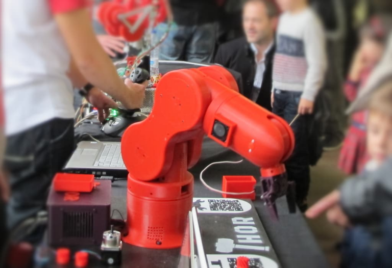 Photo of a red 3D Printed robotic arm
